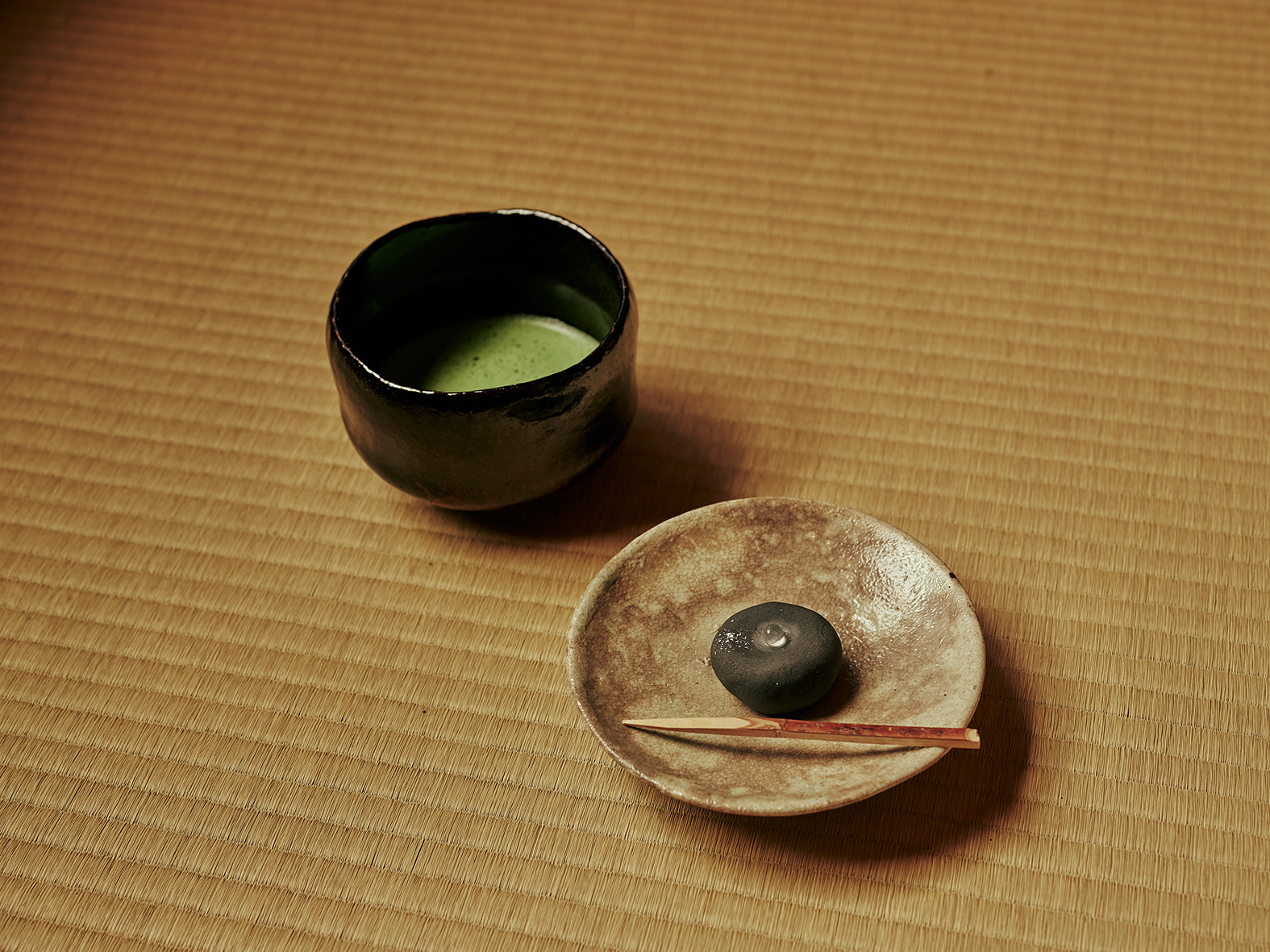 A bowl of matcha and a traditional Japanese sweet served at the Masaki Memorial Residence